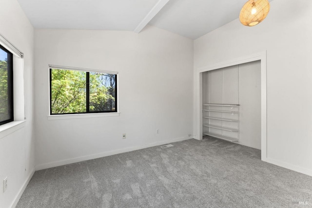 unfurnished bedroom with baseboards, carpet flooring, visible vents, and beam ceiling