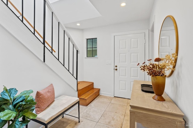 foyer entrance with baseboards, stairs, recessed lighting, and light tile patterned floors