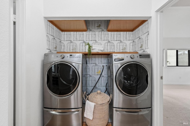 clothes washing area featuring washing machine and dryer and carpet floors