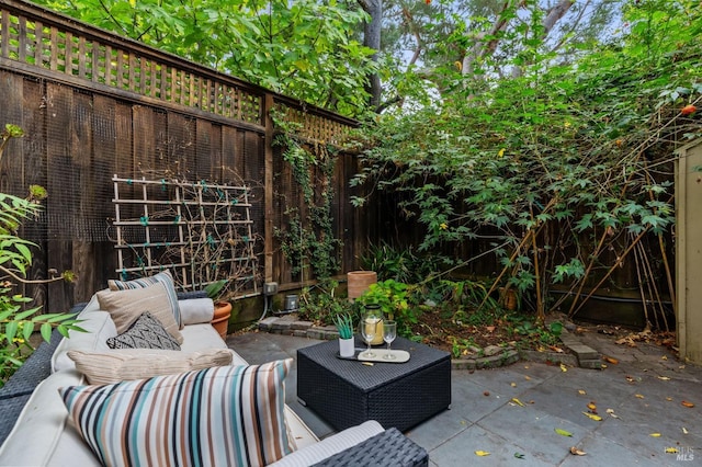 view of patio featuring an outdoor living space and a fenced backyard