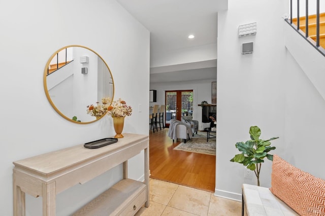 hall featuring french doors and light hardwood / wood-style floors