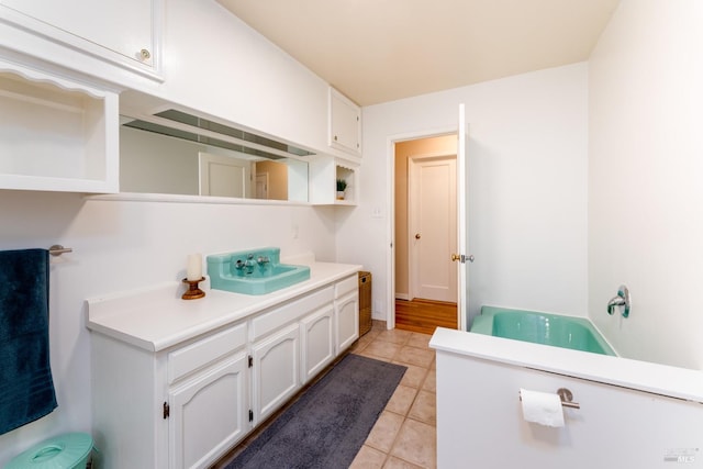 bathroom with vanity, a bathing tub, and tile patterned floors