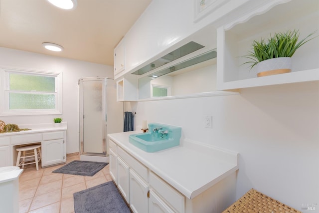 bathroom featuring vanity, a shower with shower door, and tile patterned floors