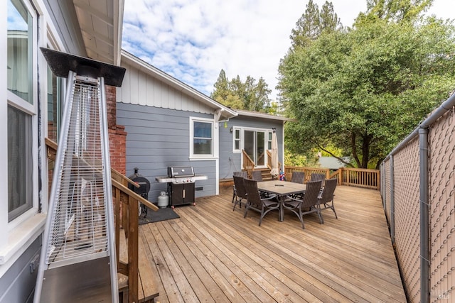 wooden deck with a grill