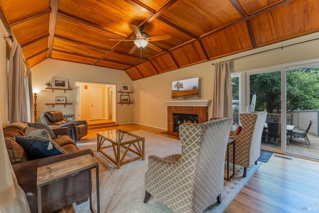 living room featuring light hardwood / wood-style floors, wooden ceiling, a fireplace, and vaulted ceiling