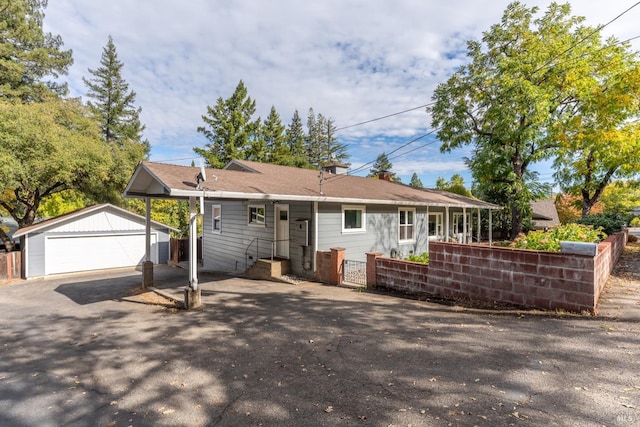 single story home with a garage and an outbuilding