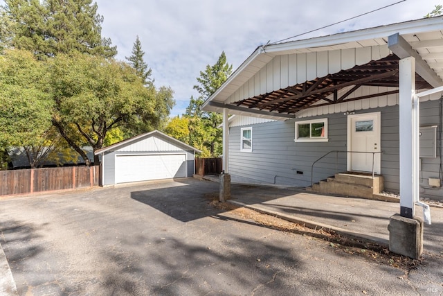 view of side of property with an outdoor structure and a garage