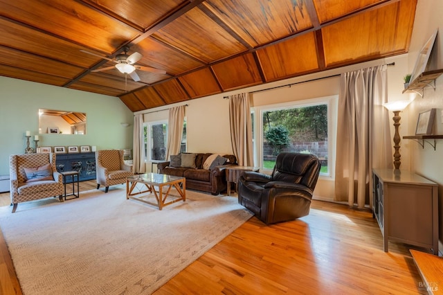 living room with vaulted ceiling, wooden ceiling, light wood-type flooring, and ceiling fan