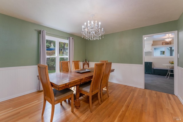 dining room with a chandelier and light hardwood / wood-style floors