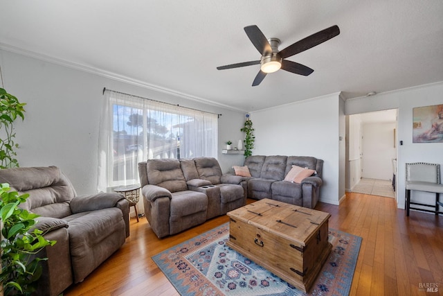 living room with wood-type flooring, ceiling fan, and crown molding