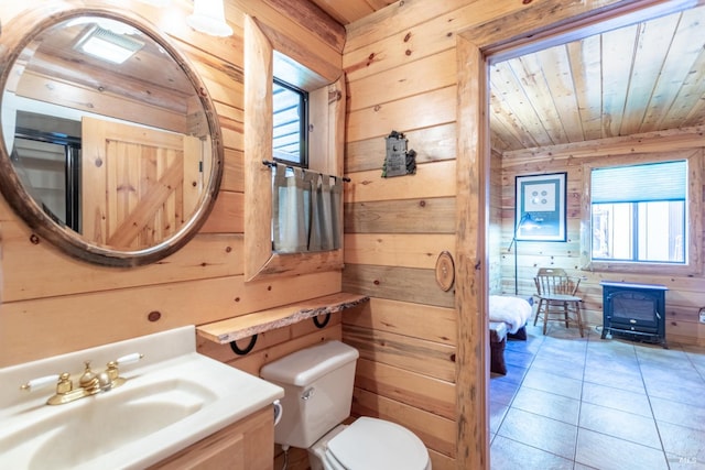 bathroom featuring wood ceiling, toilet, wooden walls, vanity, and tile patterned flooring