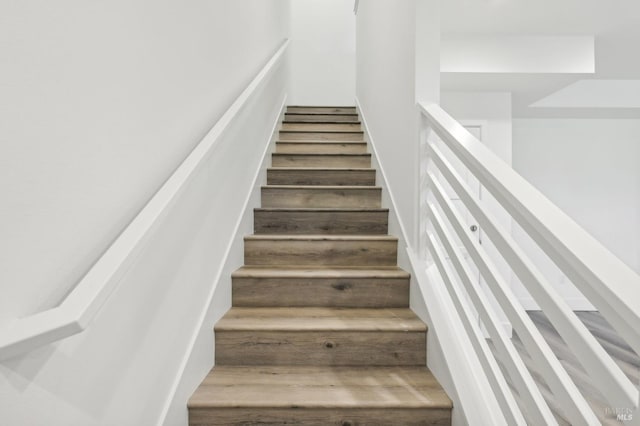 stairs featuring hardwood / wood-style flooring