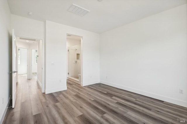 interior space with visible vents, baseboards, and wood finished floors