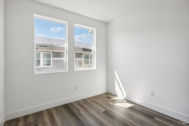 spare room featuring dark hardwood / wood-style flooring