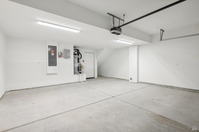 garage featuring electric panel and a garage door opener