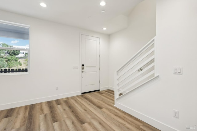 entrance foyer with recessed lighting, light wood-style flooring, and baseboards