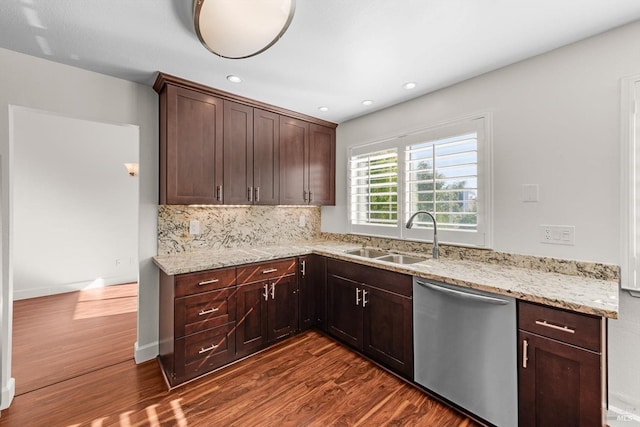 kitchen featuring sink, light stone countertops, backsplash, dark wood-type flooring, and dishwasher