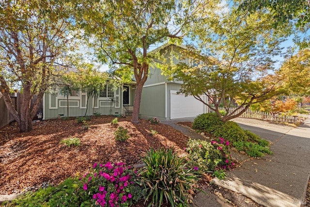 obstructed view of property with a garage