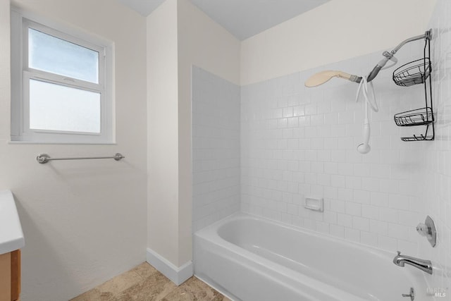 bathroom with vanity and tiled shower / bath combo