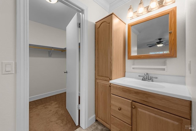 bathroom with vanity, ceiling fan, and crown molding