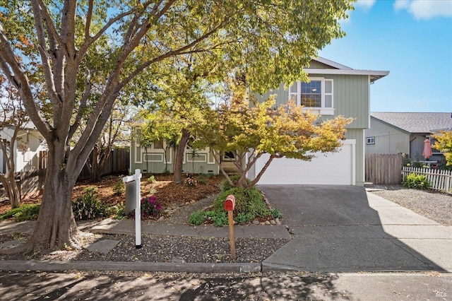 view of property hidden behind natural elements with a garage