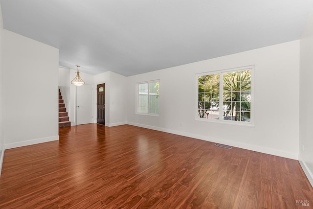 unfurnished living room featuring dark wood-type flooring