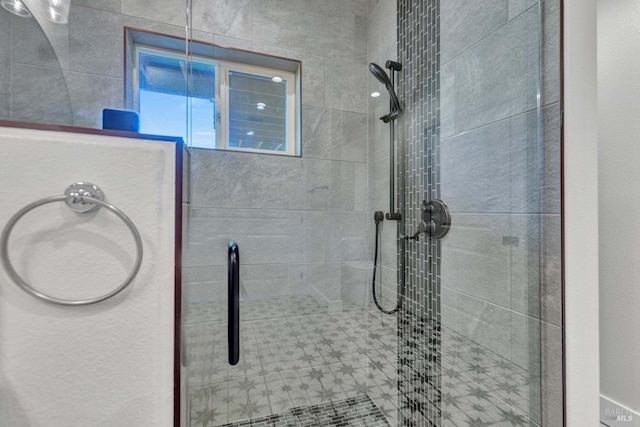 bathroom with a tile shower