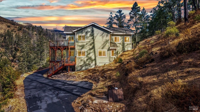 view of home's exterior featuring a wooden deck and stairs