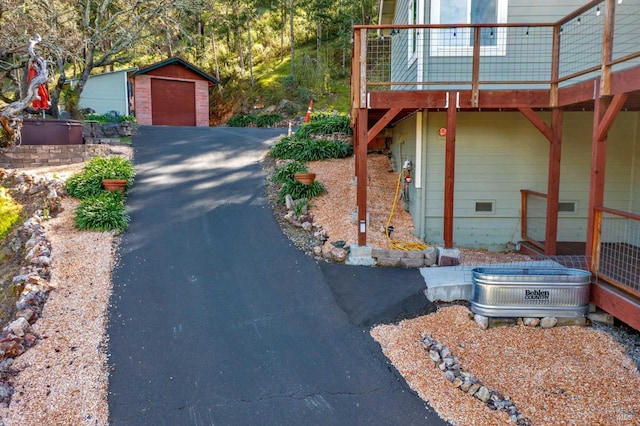 view of side of home featuring a garage and an outdoor structure