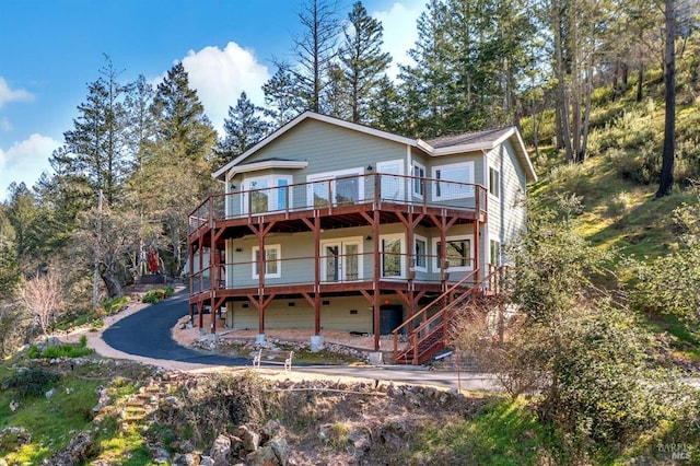 view of front facade featuring stairway and a wooden deck