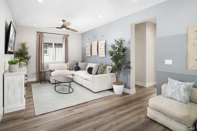 living room featuring hardwood / wood-style flooring and ceiling fan