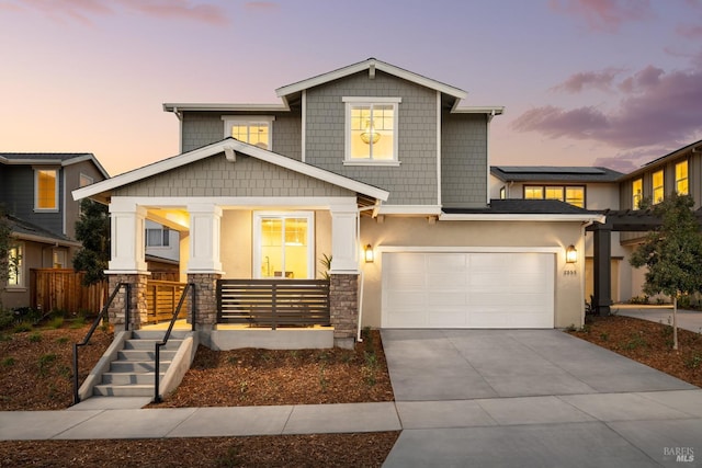 view of front of home featuring a garage and a porch