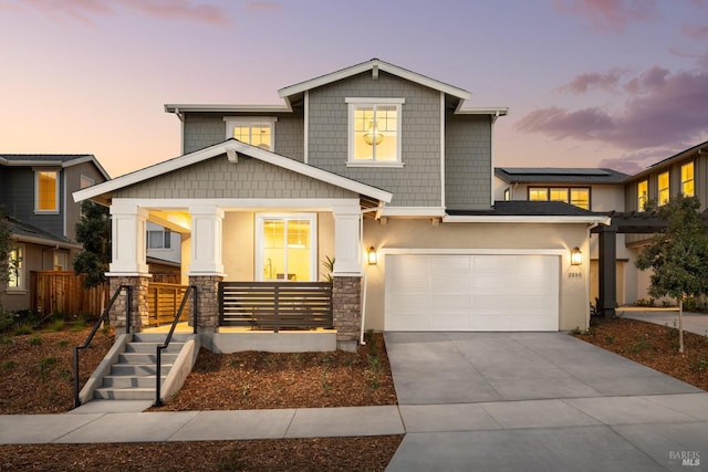 view of front of home featuring a garage and a porch