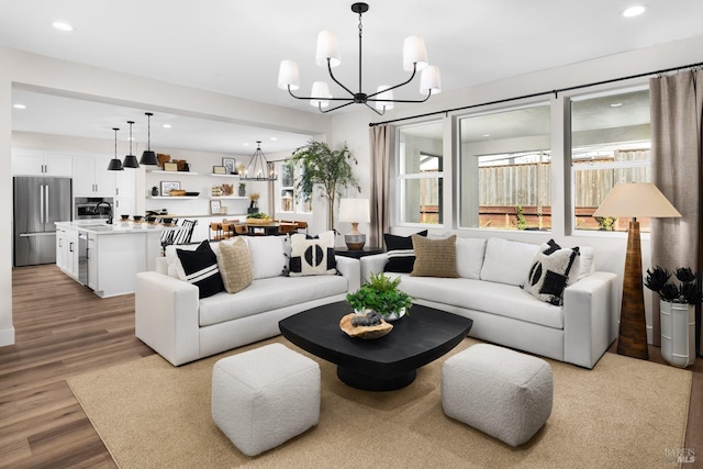 living room with light hardwood / wood-style floors and a chandelier