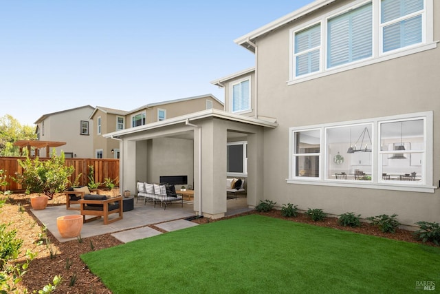 back of house featuring a yard and a patio area