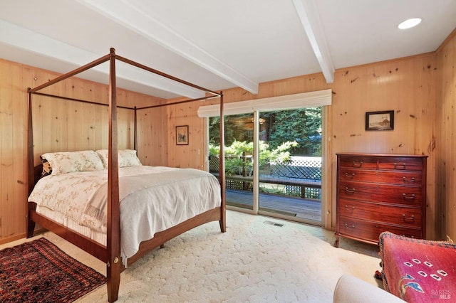 bedroom featuring access to outside, beamed ceiling, visible vents, and wooden walls