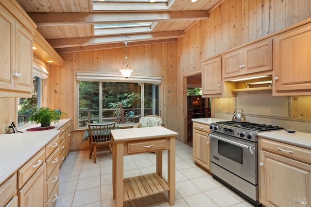 kitchen featuring pendant lighting, light countertops, high end stainless steel range oven, and light brown cabinetry