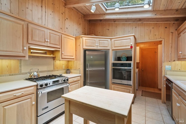 kitchen featuring appliances with stainless steel finishes, light countertops, and light brown cabinetry