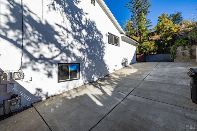 view of property exterior with a patio