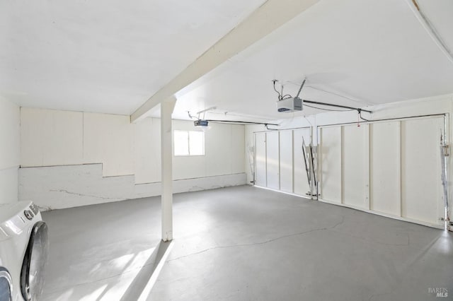 garage featuring washer / clothes dryer and a garage door opener