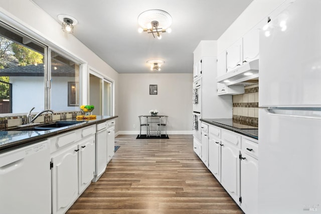 kitchen featuring white cabinets, dark hardwood / wood-style flooring, sink, and white appliances