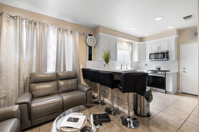 tiled living room featuring sink