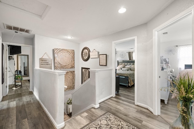 corridor with hardwood / wood-style floors