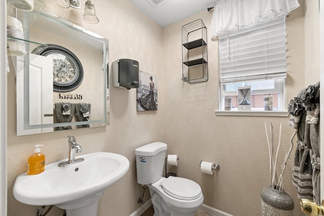 bathroom featuring sink and toilet