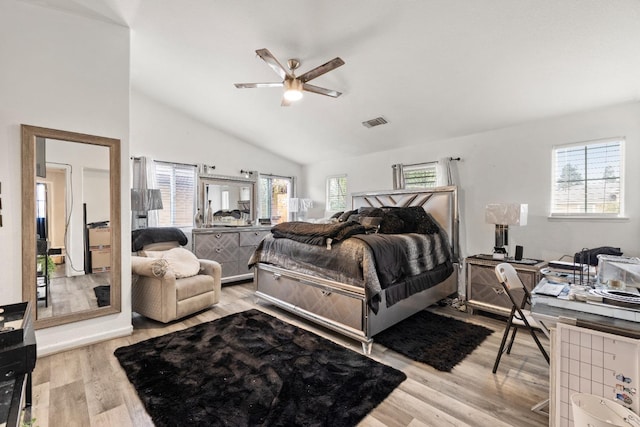 bedroom with vaulted ceiling, light hardwood / wood-style flooring, and ceiling fan