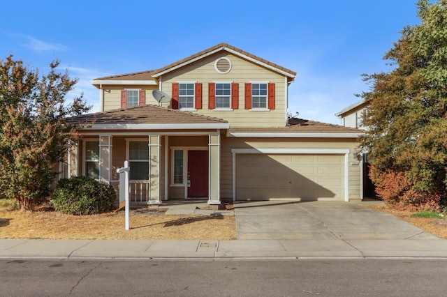 view of property with a porch and a garage