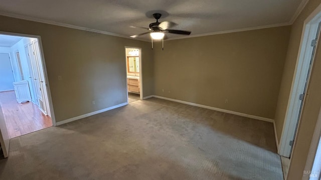 unfurnished bedroom with ensuite bathroom, carpet, ornamental molding, and ceiling fan