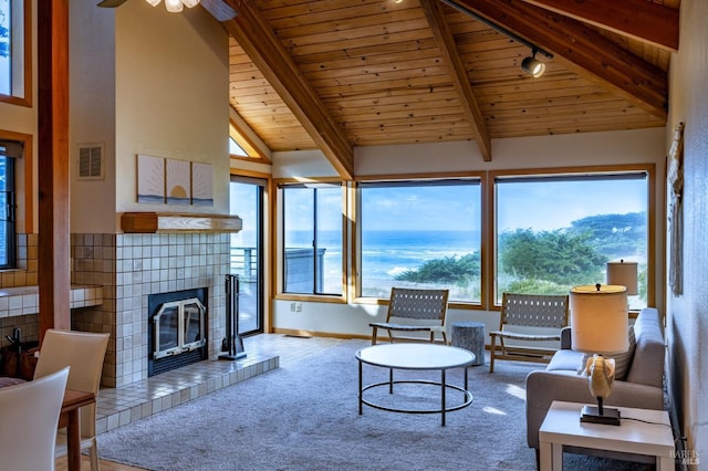 464 Sea Stack, The Sea Ranch, CA 95497 - carpeted living area featuring wooden ceiling, a ceiling fan, a tile fireplace, and a water view