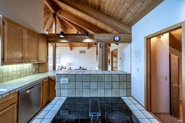 kitchen featuring sink, tasteful backsplash, high vaulted ceiling, tile countertops, and appliances with stainless steel finishes