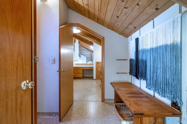 kitchen with backsplash, tile countertops, wooden ceiling, dishwasher, and vaulted ceiling with beams